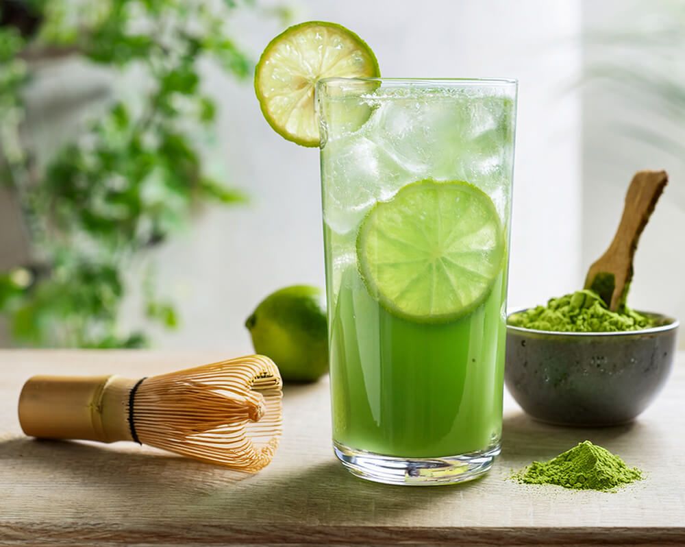 Matcha tonic z limonką w wysokiej szklance z lodem